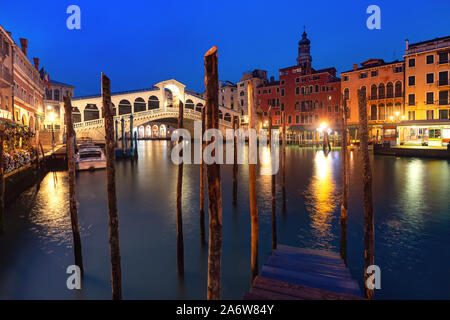 Famous Rialto Bridge or Ponte di Rialto over the Grand Canal in Venice during evening blue hour, Italy. Stock Photo