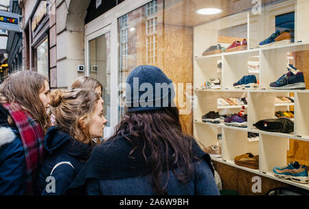 Strasbourg France Dec 27 2017 Group of young female women admiring the showcase window of a shoe store in central part of the city Nike New Balance Salomon brands for sale Stock Photo Alamy