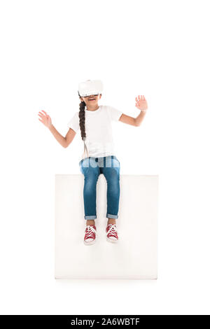happy kid gesturing while wearing virtual reality headset isolated on white Stock Photo