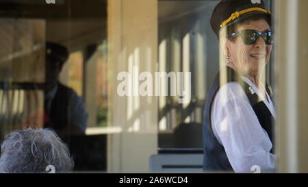 Train conductor taking tickets on a historic Sierra Railway steam engine train at Railtown 1897 State Historic Park in Jamestown, California, USA. Stock Photo