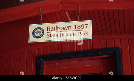 Sign: 'Railtown 1897 State Historic Park' on preserved red caboose. Railroad and train museum. California State Park. Jamestown, California, USA Stock Photo