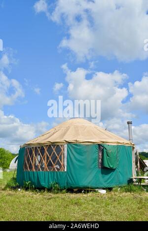 Traditional canvas yurt home with chimney at a small farm outside during sunny daytime in summer, in Decorah, Iowa, USA. Stock Photo