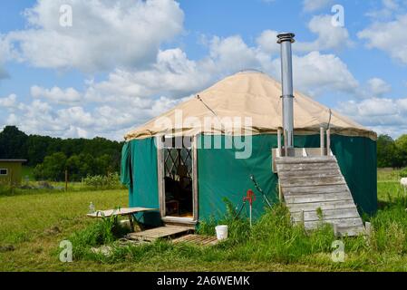 Traditional canvas yurt home with chimney at a small farm outside during sunny daytime in summer, in Decorah, Iowa, USA. Stock Photo