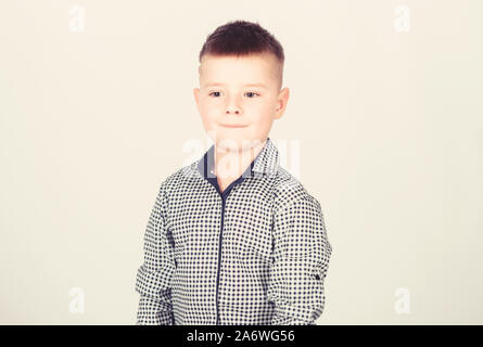 Boy modern hairstyle wear formal style shirt light background. Confident guy enjoy fashionable outfit. Try being handsome and stylish. Know lot about style. Found his style. Adorable small kid. Stock Photo