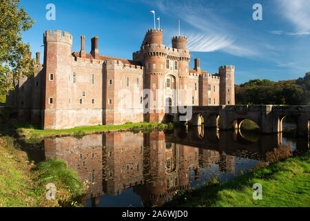 Herstmonceux Castle, a 15th century moated red brick structure, on a bright autumn morning, near Hailsham, East Sussex, England, UK Stock Photo