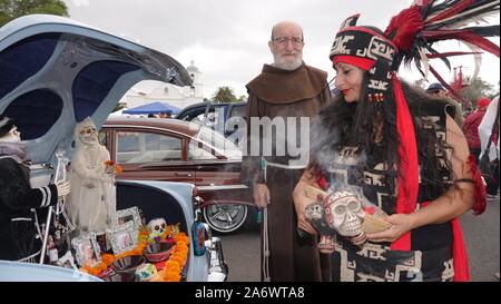 A brother from the Mission San Luis Rey and an Aztec priestess give their blessings to the altars (ofrendas) at the 2019 Day of the Dead celebration. Stock Photo