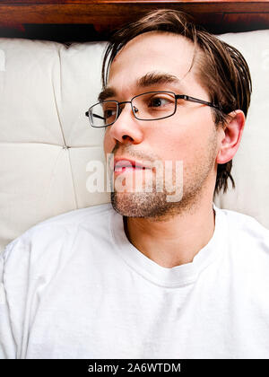 Tired Young Man Laying on Mattress - Exhausted Stock Photo