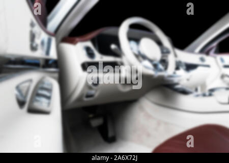 Blurred image of car interior. Dashboard. Blur defocused transportation background. Driving inside car. Bokeh light background Stock Photo