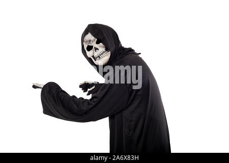 The grim reaper or death halloween costume isolated on a white background.  The skeleton is wearing a hooded black robe. Side view in profile for comp Stock Photo