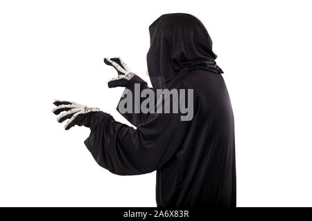 The grim reaper or death halloween costume isolated on a white background.  The skeleton is wearing a hooded black robe. Side view in profile for comp Stock Photo