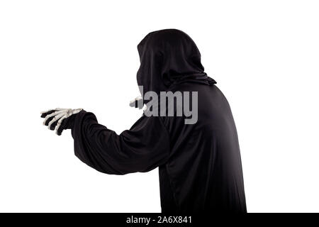 The grim reaper or death halloween costume isolated on a white background.  The skeleton is wearing a hooded black robe. Side view in profile for comp Stock Photo