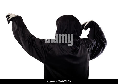 The grim reaper or death halloween costume isolated on a white background.  The skeleton is wearing a hooded black robe. Side view in profile for comp Stock Photo