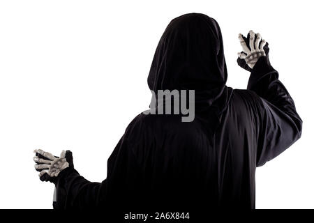 The grim reaper or death halloween costume isolated on a white background.  The skeleton is wearing a hooded black robe. Side view in profile for comp Stock Photo