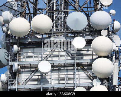 Group of antennas, satellite dishes for telecommunications, television broadcast, cellphone, radio and satellite on Linzone mountain peak Stock Photo