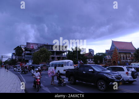 Dark storm clouds loom over Wat Ounalom & chaotic traffic on Sisowath Quay Boulevard. the riverside, Phnom Penh, Cambodia. © Kraig Lieb Stock Photo
