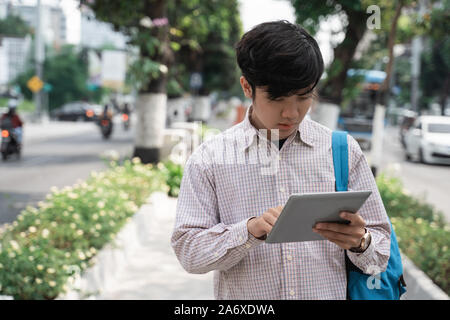 Young student browsing using a digital tablet Stock Photo