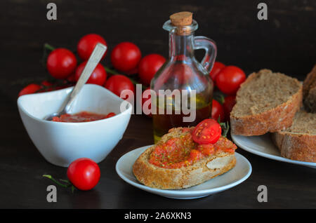 Pa amb tomaquet or tomaca (bread with tomato) also known as pan con tomate and tostada. Classic snack in Catalan cuisine, eaten for breakfast. Crusty Stock Photo