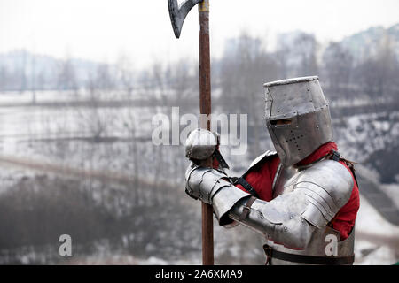 Knight stands before a battle on a battlefield in winter Stock Photo