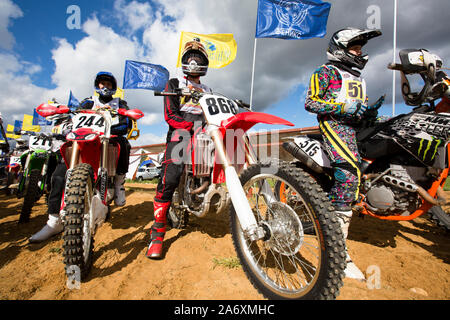 Athletes on a motorcycle at the start of cross-country competitions Stock Photo