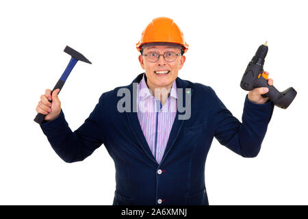 Builder in a helmet with a drill and hammer Stock Photo