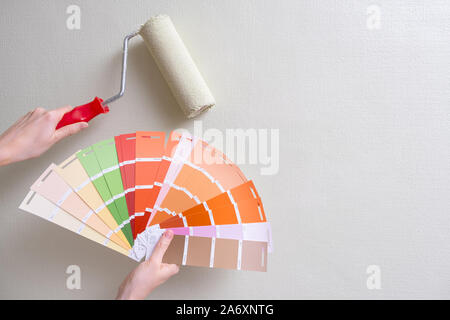 paint roller and color samples on paper Stock Photo