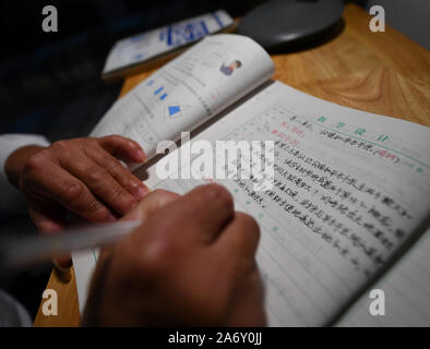 Jiangxi, China. 28th Oct, 2019. Huang Xinglai prepares lessons at his dormitory at Cunli primary school of Huping Township in Le'an Country, east China's Jiangxi Province, Oct. 28, 2019. Huang Xinglai, 61, used to be a rural teacher at Anli primary school of Wanchong Township and retired in July of 2018. He went to Cunli primary school of Huping Township and worked as a rural teacher again in January of 2019 to respond to the call of local government. In order to focus on teaching, Huang lives at school with other young teachers. Credit: Xinhua/Alamy Live News Stock Photo