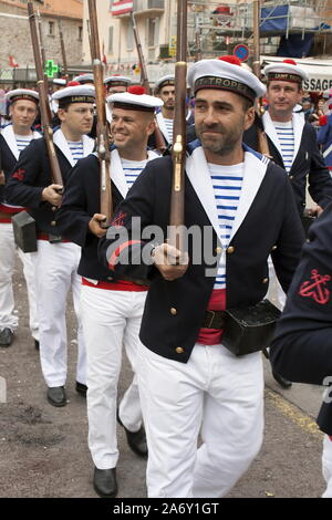 Men in vintage naval uniforms in Les Bravades festival parade in the port of St Tropez, France Stock Photo