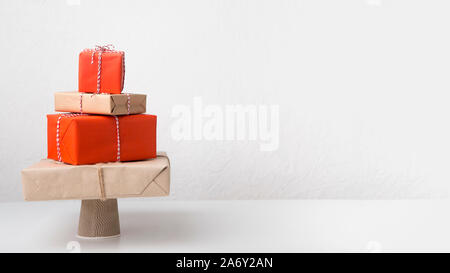 Big pile of creative wrapped presents in shape of Christmas tree Stock Photo