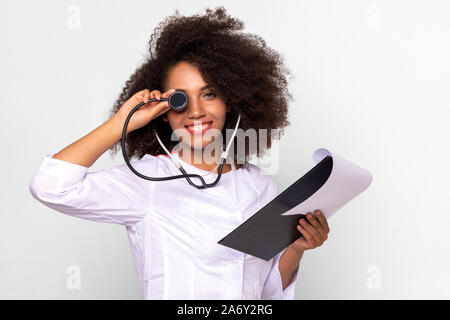 Girl doctor jokes playing with stethoscope Stock Photo