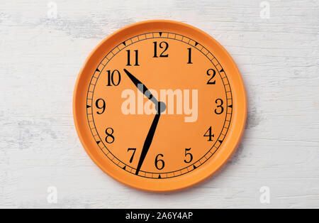 clock and dial on a plastic orange plate Stock Photo