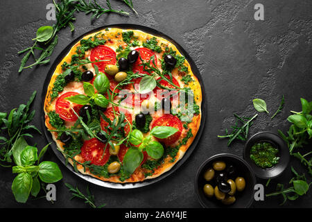 Pizza. Traditional italian pizza with green basil pesto sauce, top view Stock Photo