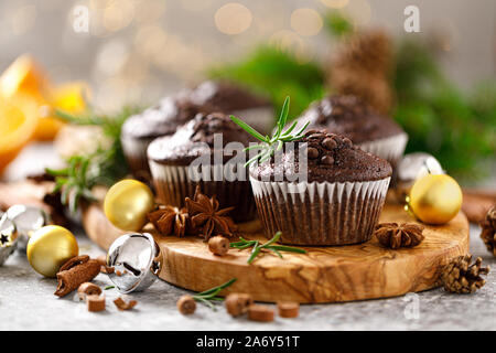 Christmas muffins. Chocolate Xmas or Noel festive bake with decorations and fir tree Stock Photo