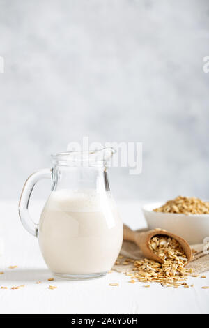 Oat milk. Healthy vegan non-dairy organic drink with flakes Stock Photo