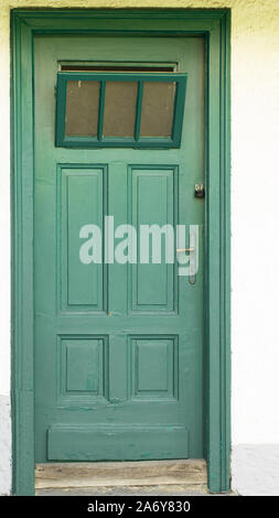 old wooden green door in austria Stock Photo