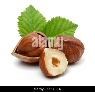 Group of hazelnuts with green leaves isolated on white background Stock Photo
