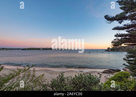 Looking across Port Hacking from Gunyah Beach, Bundeena in southern Sydney to Hungry Point, Cronulla in the early morning. Australia Stock Photo