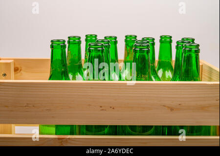 Empty wine bottles in a wooden box on the table. Home winemaking Stock Photo