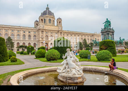Vienna, Austria - September 1, 2019: The girl sits by the fountain in front of the Natural History Museum in Vienna, Austria Stock Photo