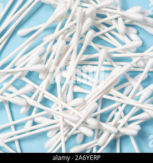 some cotton swabs on a blue surface Stock Photo