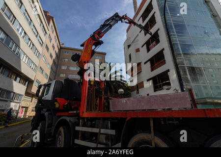 Coruna / Spain - October 23 2019: Iveco Truck with Palfinger crane making a challenging kerb side delivery into an apartment block in Coruna Spain Stock Photo