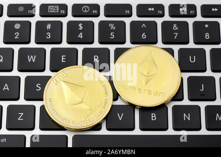 Ethereum coins on laptop keyboard. Cryptocurrency. Selective focus - image Stock Photo