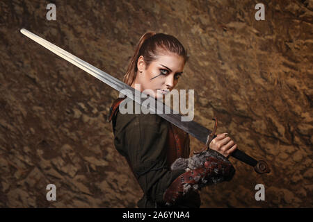 Beautiful warrior woman posing with sword Stock Photo