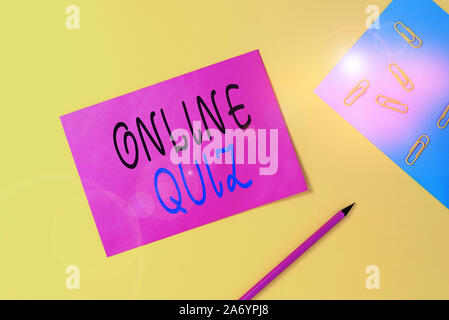 Writing note showing Online Quiz. Business concept for game or a mind sport that are published on the Internet Blank paper sheets message pencil clips Stock Photo