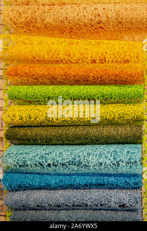 Modern packaging wicker and openwork materials for florists. Delicate pearlescent tone of the material. The colored coils on the window market. Stock Photo