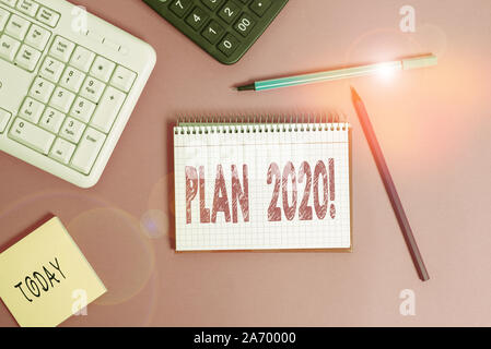 Writing note showing Plan 2020. Business concept for detailed proposal doing achieving something next year Writing equipments and computer stuff place Stock Photo
