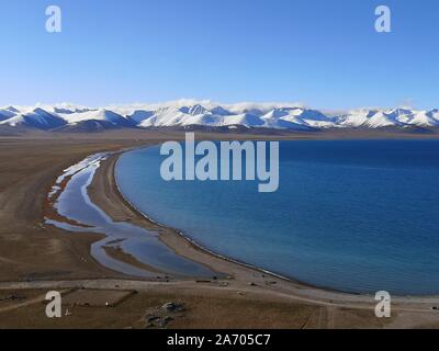 View of Namtso lake with snow capped mountains, Tibet. Namtso is the largest lake in the Tibet Autonomous Region Stock Photo