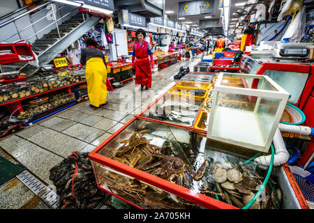 Busan Korea , 2 October 2019 : Jagalchi fish market alley view with alive crabs and fishes cases in Busan South Korea Stock Photo