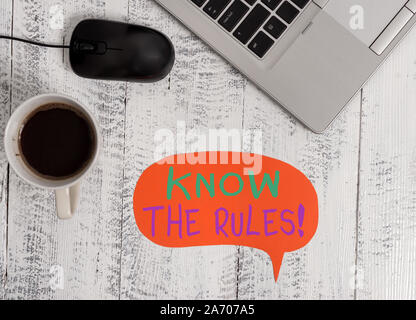 Handwriting text Know The Rules. Conceptual photo set explicit or regulation principles governing conduct Open metallic laptop speech bubble mouse cof Stock Photo