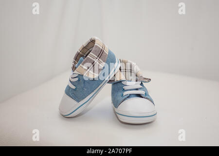Pair of trendy blue and white baby shoes. Stock Photo