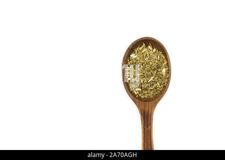 Yerba Mate Tea on wooden spoon isolated on white background. Dried yerba mate tea powder. Stock Photo